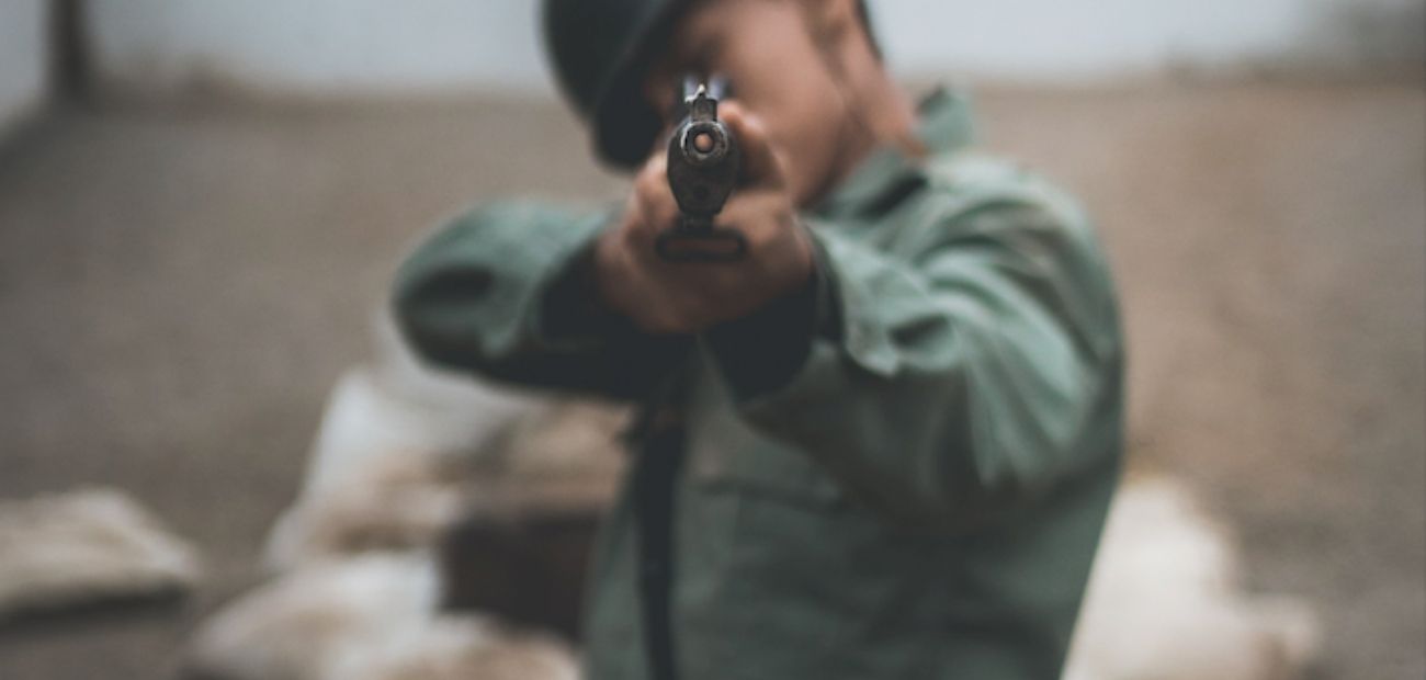A soldier aiming towards a camera shot with a gun